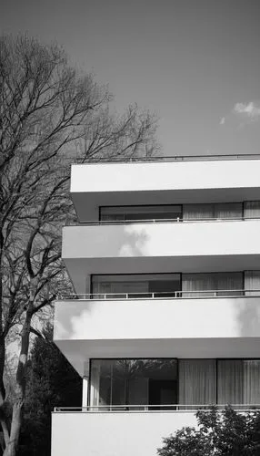 Gray, modern, flat-roofed, residential building, detailed textured gray architectural shingles, slight gradient effect, geometric pattern, minimalist facade, clean lines, rectangular windows, sliding 