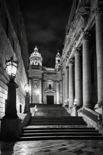 Malta architectural monument, grand entrance, Baroque style, intricate stone carvings, golden lanterns, warm soft lighting, dramatic spotlights, ambient glow, high ceilings, ornate columns, grand stai