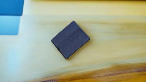 a rectangular piece of wood sitting on a table,cube surface,isolated product image,a plastic card,square card,ferrimagnetic,thermoelectric