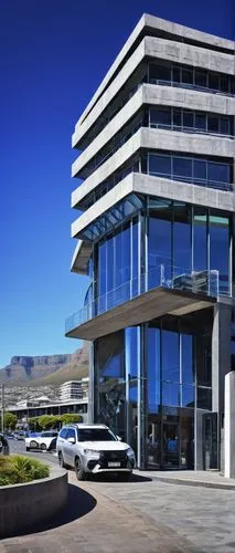 Modern architectural building, Cape Town, South Africa, Table Mountain background, contemporary sleek lines, large glass windows, minimalist decor, steel structure, concrete foundation, urban cityscap