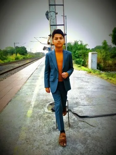 Change his boy suit in coat pants,a man in a suit walks along side railroad tracks,indian railway,chintu,rajveer,duronto,guntakal,sarvan,siddhant,railwayman,abhinav,agasthya,rizvan,arjun,samarth,prith