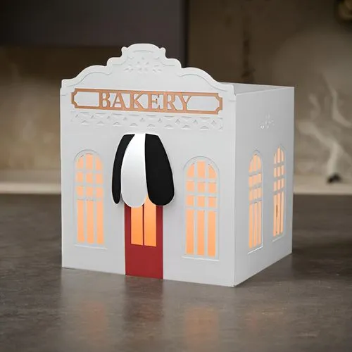 A table in a historical and ancient setting.,an interesting white cake box on a table,danbo cheese,christmas lantern,christmas packaging,chanukah,chatterbox,paperchase,Small Objects,Indoor,Modern Kitc