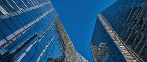 Modern skyscraper, sleek glass facade, silver metallic accents, intricate stone veneer patterns, urban cityscape, bustling streets, daytime, clear blue sky, few puffy white clouds, dramatic angles, lo