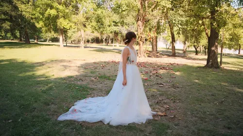 girl in a long dress from the back,wedding dress,bridal dress,girl in a long dress,wedding gown,wedding photography,wedding dresses,walking down the aisle,wedding dress train,bridal veil,wedding photo