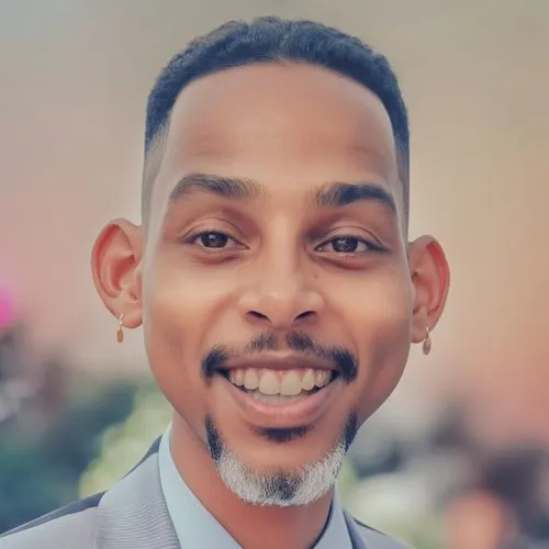 a young man wearing a suit smiles at the camera,raja,mekonnen,mulugeta,abdiaziz,woldemariam,abdirizak,eritrean,kweisi,zwelakhe,linkedin icon,abdirashid,berhanu,rafique,jelani,samatar,abdelilah,garaad,