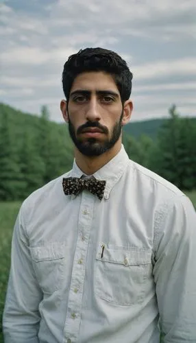 slightly above eye-level, composition,the man in the bow tie is posing for a po,wooden bowtie,abderahmane,hasan,belkacem,tawhidi,kohila,kaysar,mohammadzadeh,samiullah,safian,saeid,kasra,zabiullah,solt