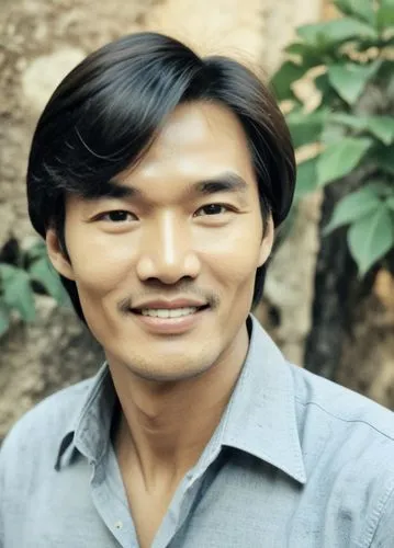 a smiling man in blue shirt posing for a picture,khandu,chakma,bhutia,adipati,kwanchai,narongchai