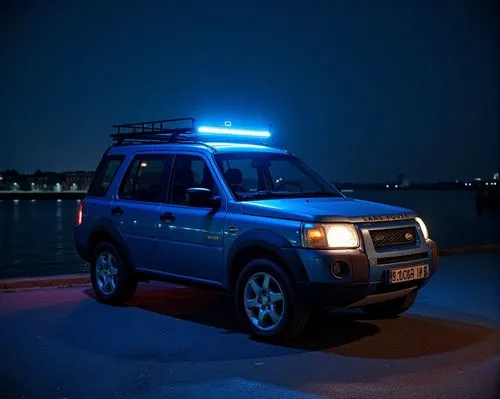 (High Definition HD) 2000 Land Rover freelander SUV 4x4w 3 door car decorated as a blue low car, parked by the sea at night.,a blue suv sits parked on a dock,freelander,4 runner,pajero,landcruiser,pat