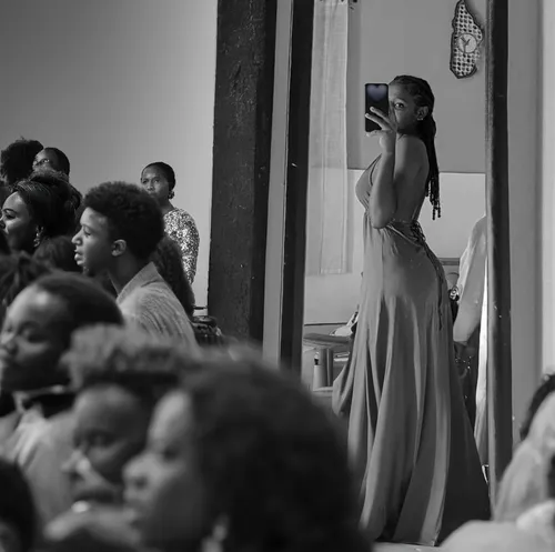 Beautyfull young african woman on the scene. Black and white. Watched by many spectators in a Fashion public show,girl in a long dress from the back,rwanda,girl in a long dress,a girl with a camera,fa