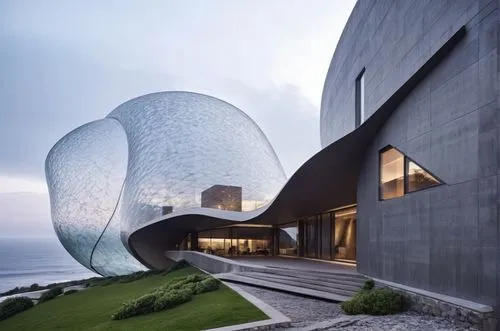 an architectural masterpiece inspired by the elegant and organic form of a snail. The building should be perched on a majestic cliff, offering panoramic views of the ocean. The design should incorpora