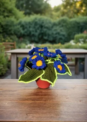 a crocheted vase filled with blue flowers on a table,flower pot holder,wooden flower pot,fabric flower,fabric flowers,felt flower,flower bowl,Small Objects,Outdoor,Garden