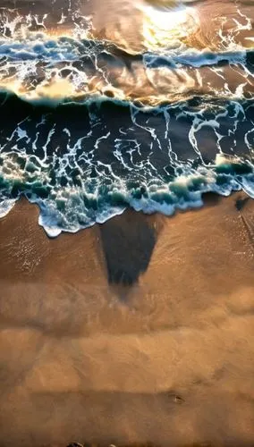 two surfers in the surf and one flying overhead,aerial view of beach,sand waves,water waves,ocean background,beach erosion,sand ripples