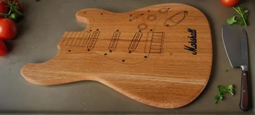 On the kitchen table with cutted vagetables and knife,cutting board,chopping board,cuttingboard,luthier,bass guitar,guitar easel,fender,jazz bass,electric bass,painted guitar,wood board,squier,timbale