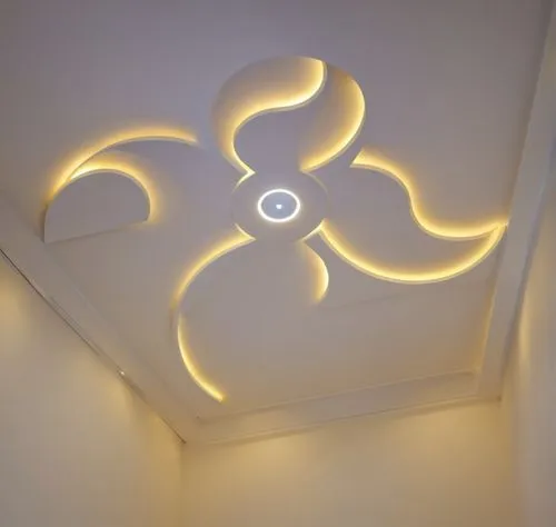 Gypsum decoration in the ceiling of a room with hidden LED lighting,modern ceiling light fixture in an otherwise white room,ceiling light,ceiling lighting,ceiling lamp,wall lamp,wall light,ceiling con