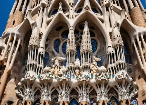 Sagrada Familia, Antoni Gaudí, architecture, grand, intricate, ornate, Gothic, Art Nouveau, Barcelona, Spain, sunny day, blue sky, white clouds, detailed stonework, curved lines, twisted columns, vibr