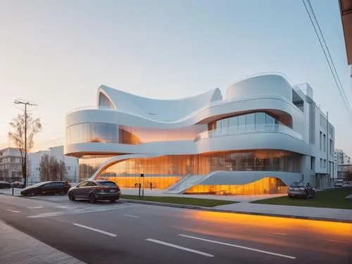 REMODELACION DE UNA PLAZA COMERCIAL, CON ARQUITECTURA NOVEDOSA,a building with curves on the side and cars passing by,morphosis,modern architecture,futuristic art museum,philharmonie,cube house,futuri