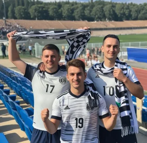 three young men at a soccer game one is holding a scarf over the houlders of the other,hessenliga,veikkausliiga,deaflympics,oberliga,bayernliga,chernomorets,team spirit,bavarians,kreisliga,chornomoret