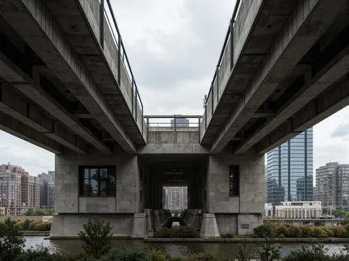 Rugged bridge structure, brutalist architecture, raw concrete surfaces, exposed ductwork, industrial materials, functional design, urban cityscape, gray cloudy sky, dramatic lighting, low-angle shot, 