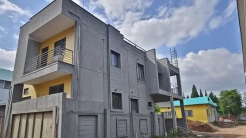 a grey building with yellow and blue windows,duplexes,parvathipuram,amrapali,new housing development,cube house,puram,Photography,General,Realistic