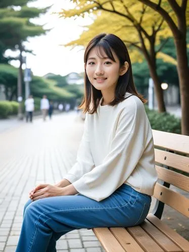 young japanese woman sits on a bench,woman sitting on bench smiling and looking forward,kaori,mikiko,sumiala,mayuko,eriko,manaka