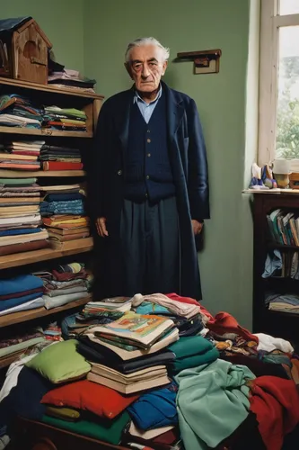 One resident stared directly at the camera as he stood in his home surrounded by his possession including a high pile of books and clothes tucked down the side of the wardrobe,elderly man,beyaz peynir