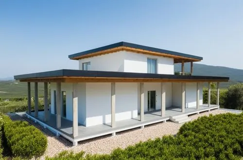 Small modern house surrounded by a cottage community.
The walls are white. Black roof.,a house on a grassy field with a dirt road,dunes house,passivhaus,inmobiliaria,modern house,cubic house,frame hou