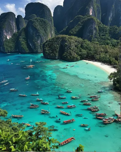 Describe the breathtaking beaches of Koh Phi Phi.,koh phi phi,krabi thailand,phang nga bay,khao phing kan,andaman sea,railay bay,southeast asia,phuket province,nusa penida,thailand,phuket,raja ampat,p