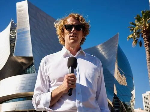 Modern Los Angeles architecture, sunny day, clear blue sky, guided tour, mature male guide, white shirt, black glasses, holding microphone, standing in front of iconic buildings, Walt Disney Concert H