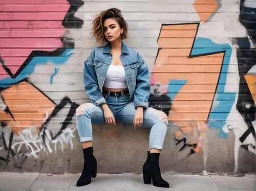 Lesbian peon, beautiful detailed eyes, bold eyebrows, short hair, light makeup, casual wear, denim jacket, white tank top, high-waisted ripped jeans, black boots, confident posture, leaning against a 