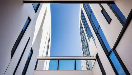 Modern architecture, futuristic building, sleek lines, minimalist design, steel beams, large glass windows, white concrete walls, flat roof, urban cityscape, metropolitan area, afternoon sun, soft sha