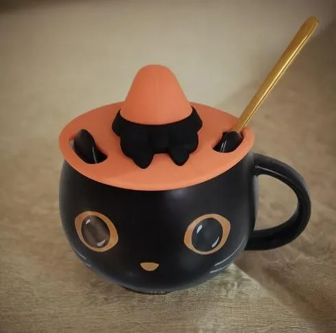 the little cat cup has a tiny orange top and it's in the shape of a hat,halloween coffee,tea party cat,tea cup fella,candy cauldron,cat coffee,cat drinking tea