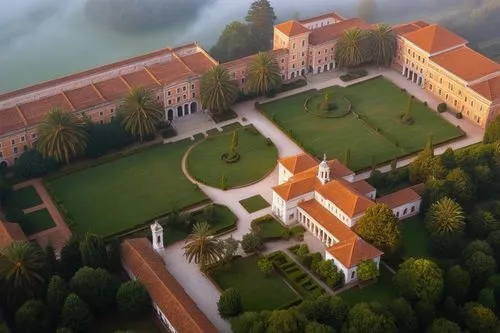 In the midle have school building
The school is surrounded by dense forest,an aerial view of a building surrounded by trees,venaria,villa d'este,villa cortine palace,villa balbiano,certosa di pavia,un