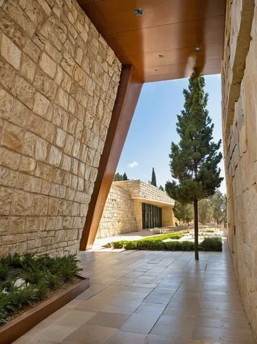 "Jerusalem Yad Vashem architecture, modern museum building, stone walls, glass roof, triangular structure, geometric shapes, memorial garden, walking path, trees with Hebrew inscriptions, Israel flag 