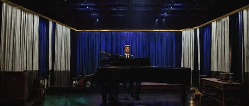 Image may contain Kyle MacLachlan Lighting Stage Interior Design Indoors Human and Person,the piano,piano,piano bar,pianos,pianist,player piano,steinway,leg and arm on the piano,grand piano,blue room,