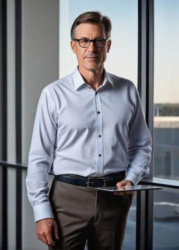 Mid-aged male, Clayton Homes architectural designer, standing confidently, bespectacled, short brown hair, clean-shaven, wearing a white button-down shirt, dark blue trousers, black leather belt, dres