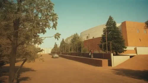 the side of a building that is next to a tree,auc,djougou,masdar,campus,pnu,ouarzazate,Photography,Documentary Photography,Documentary Photography 01