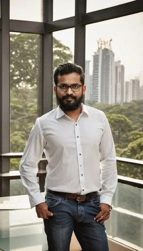 Male architect, designer, Bangalore, 30s, stylish hair, black rimmed glasses, trimmed beard, white shirt, dark blue jeans, brown leather shoes, holding blueprints, standing, modern office interior, gl