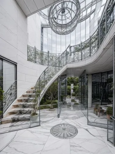 marble floor,circular staircase,winding staircase,outside staircase,glass wall,glass facade,structural glass,spiral staircase,spiral stairs,steel stairs,glass building,staircase,stone stairs,revolving