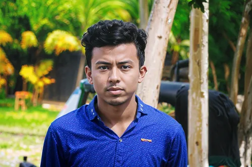 man with text on his shirt in front of trees,nazmul,biswajit,ashraful,grameenphone,papon,prempro