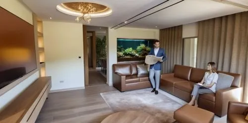 transparent glass of a fish tank over looking the dining area,two women are standing in the living room watching television,modern room,smartsuite,japanese-style room,guestrooms,great room,modern deco