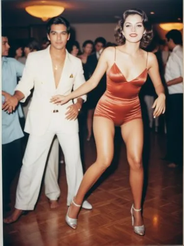 Grand beauty on the dance floor. Her lover behind.,woman in short red swimsuit dancing on floor next to man in white suit,bailar,salsoul,danceteria,charanga,milonga,lambada,Photography,Documentary Pho