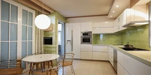 The floor is glossy beige tile, glass table, kitchen set, glossy white refrigerator, wooden countertop, metal trim handles of the refrigerator, hob, oven, microwave and extractor hood above the stove 