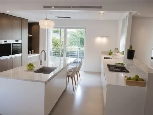 A kitchen design with smooth, handleless white cabinet fronts. The cabinets feature clean, modern lines, creating a minimalist and sleek aesthetic. The overall feel is one of order and elegance, with 