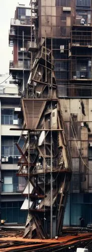 tokyo, conceptual slum tower, suspended cables , power supplying tubes, structure made up of dirty glass ,rusty metal beams and eroded metal sheets,an industrial building that appears to be being buil