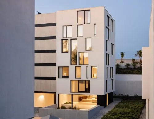 WHITE FACADE AND MAKE BALCK WALLS TO  
CONCRETE,a tall white building with windows and lights,mahdavi,corbu,fresnaye,neutra,modern architecture,cubic house,dunes house,modern house,residential,eisenma