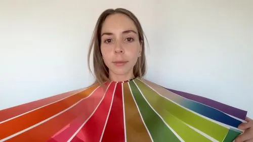 respect the pantone colors,woman holding up a color wheel over her face,paper umbrella,color fan,winebow,color circle,colorama,cocktail umbrella