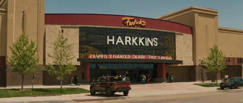 Craft a heartwarming moment that takes place at Harkins Theater Arvada.,harris shell,handicap parking,horse supplies,mandarin house,harp of falcon eastern,building exterior,shopping center,headquarter