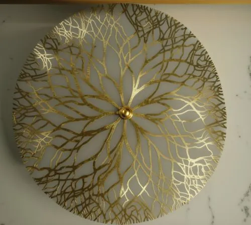 render this side table with a clean sophisticated look make top in stenciled rough brass and base black in marble, give alot of detailing.,a close up of a white plate on a table,gold foil tree of life