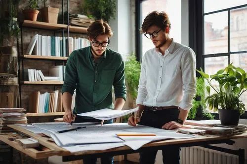 Architecture design studio, male designer, 25yo, messy brown hair, black-framed glasses, casual wear, white shirt, dark jeans, sneakers, holding a pencil, standing in front of a large drafting table, 