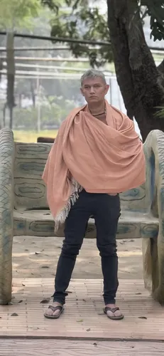  man stands on the boardwalk with a blanket over his shoulders,chandraswami,bahaji,indian monk,gandhiji,krishnaism,ilayaraja